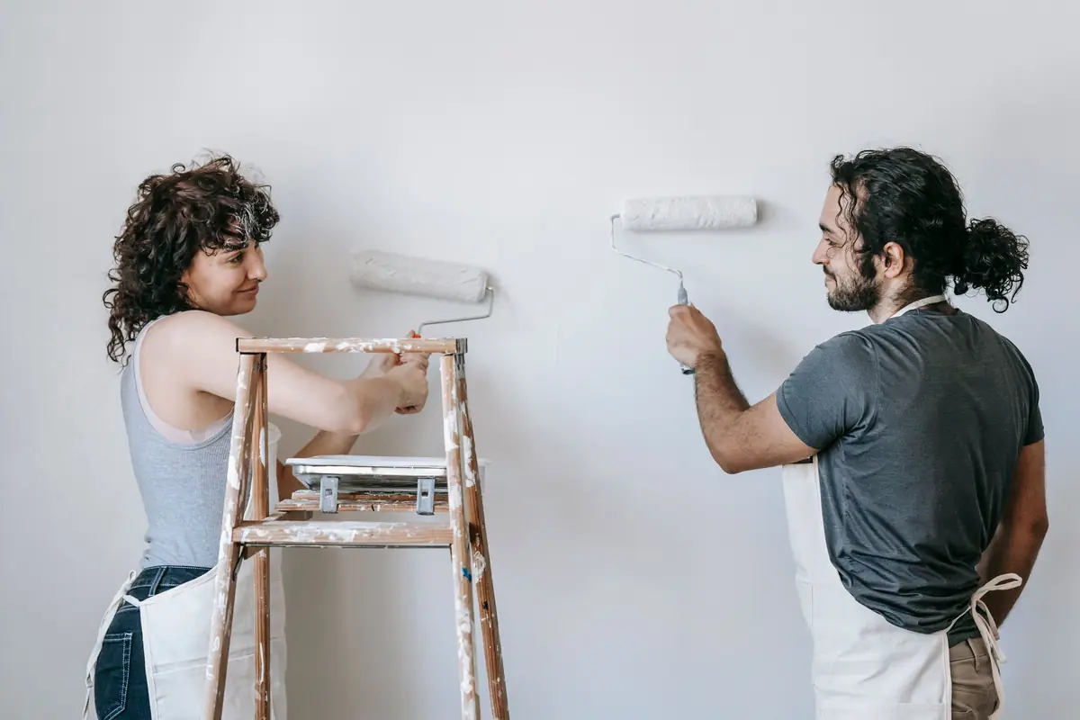 People painting a wall together — painting help in Chicago