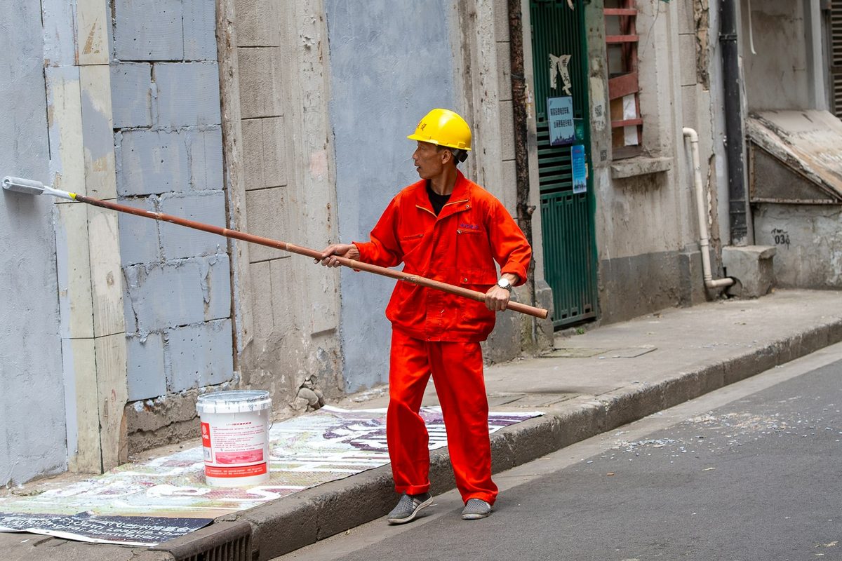 Painter working on a building exterior