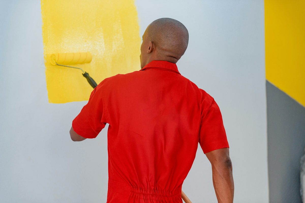 Painter at work on a wall